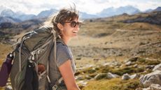 Does hiking build muscle? Image shows woman hiking in the mountains