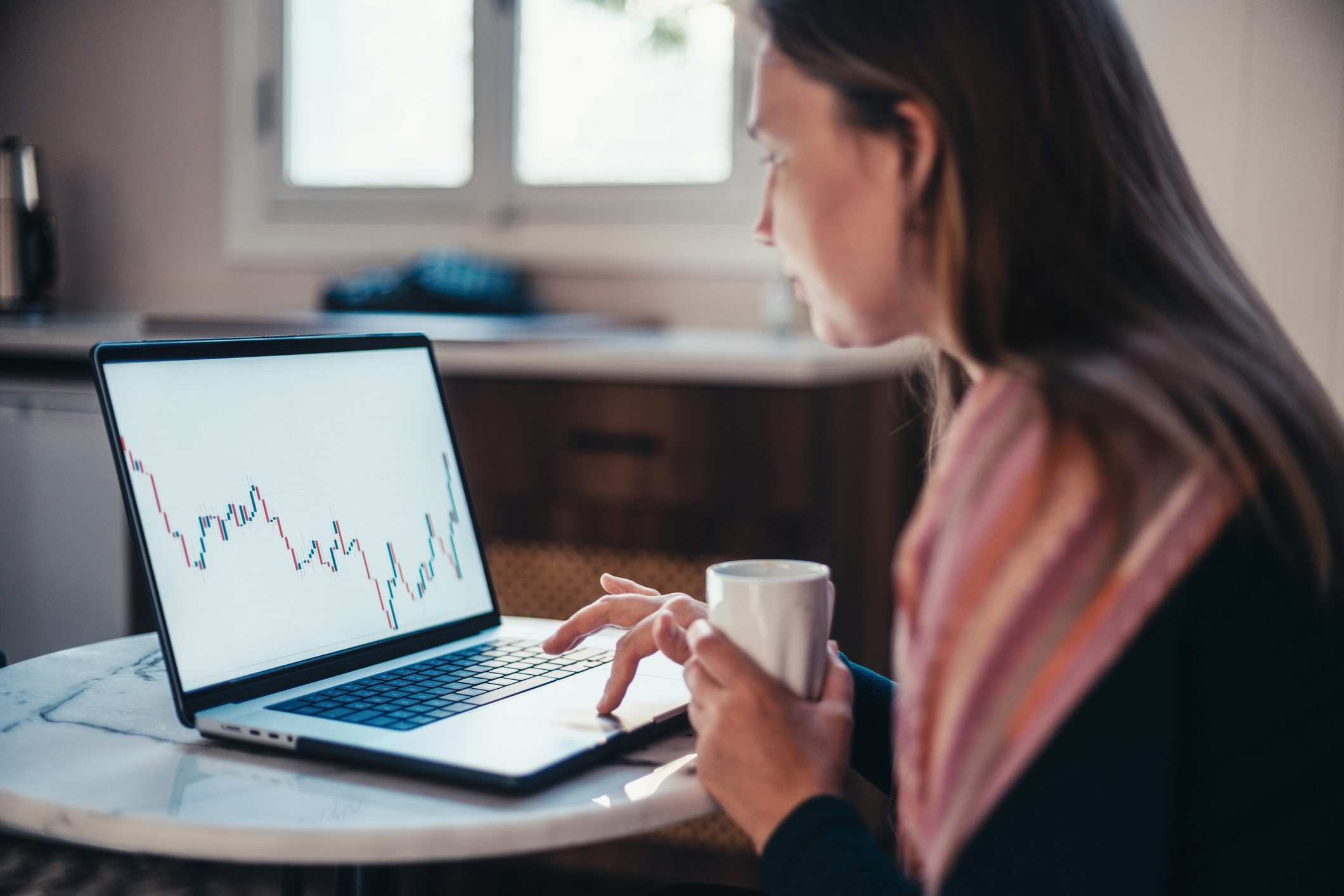 Woman Checking Her index fund Investments Using Laptop Computer