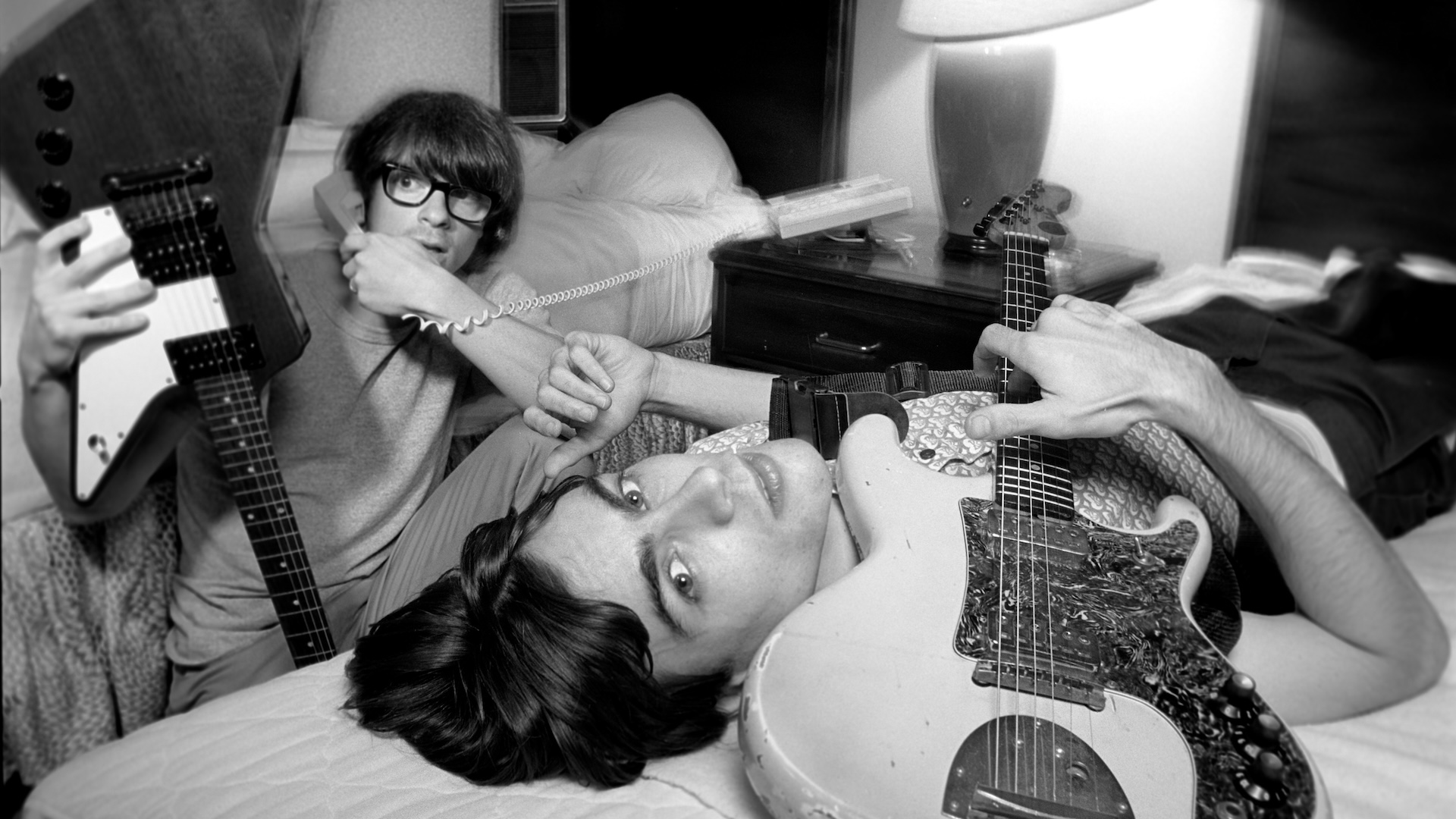 Rivers Cuomo (left) and Brian Bell (right) relax at their hotel before a Weezer show on August 26, 1994 in New York City, New York