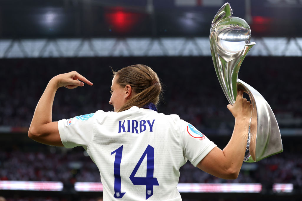 Fran Kirby of England indicates her name on the reverse of her jersey as she poses with the trophy following the UEFA Women's Euro England 2022 final match between England and Germany at Wembley Stadium on July 31, 2022 in London, England.