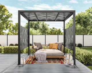 a black pergola with privacy screens and a seating area on a deck