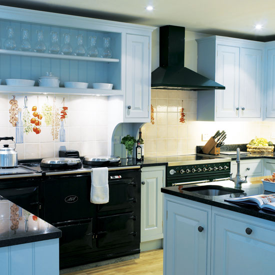 kitchen with blue cabumet white wall electric stove and chimney