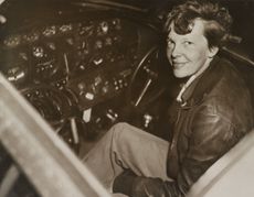 Amelia Earhart sitting in the cockpit of her Lockheed Electra airplane. In July 1937, Earhart and the plane were last seen on July 2, 1937 over the Pacific Ocean.