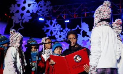 First lady Michelle Obama reads a story to children at the National Christmas Tree Lighting Ceremony in 2009.