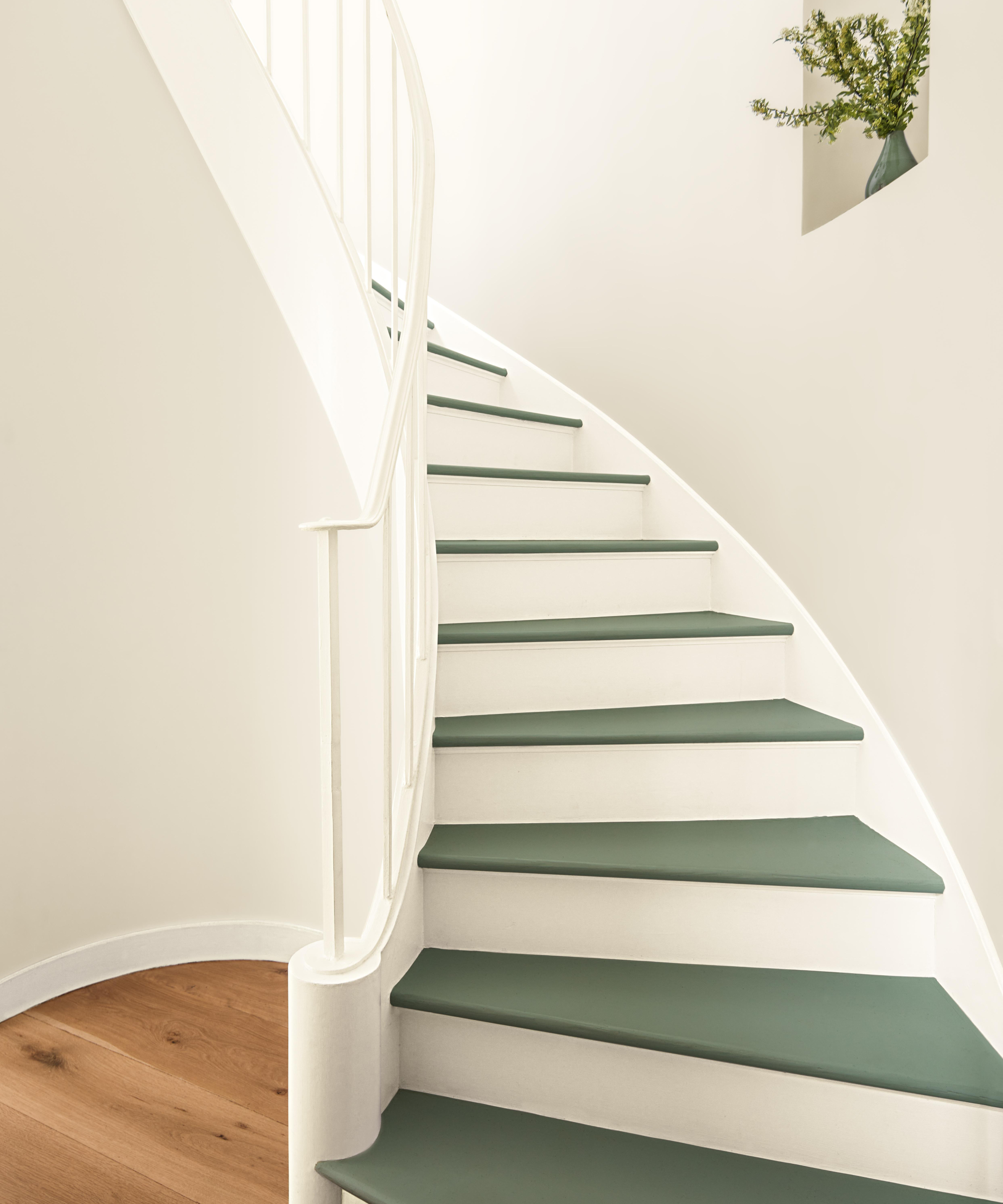white painted stairs with green painted treads