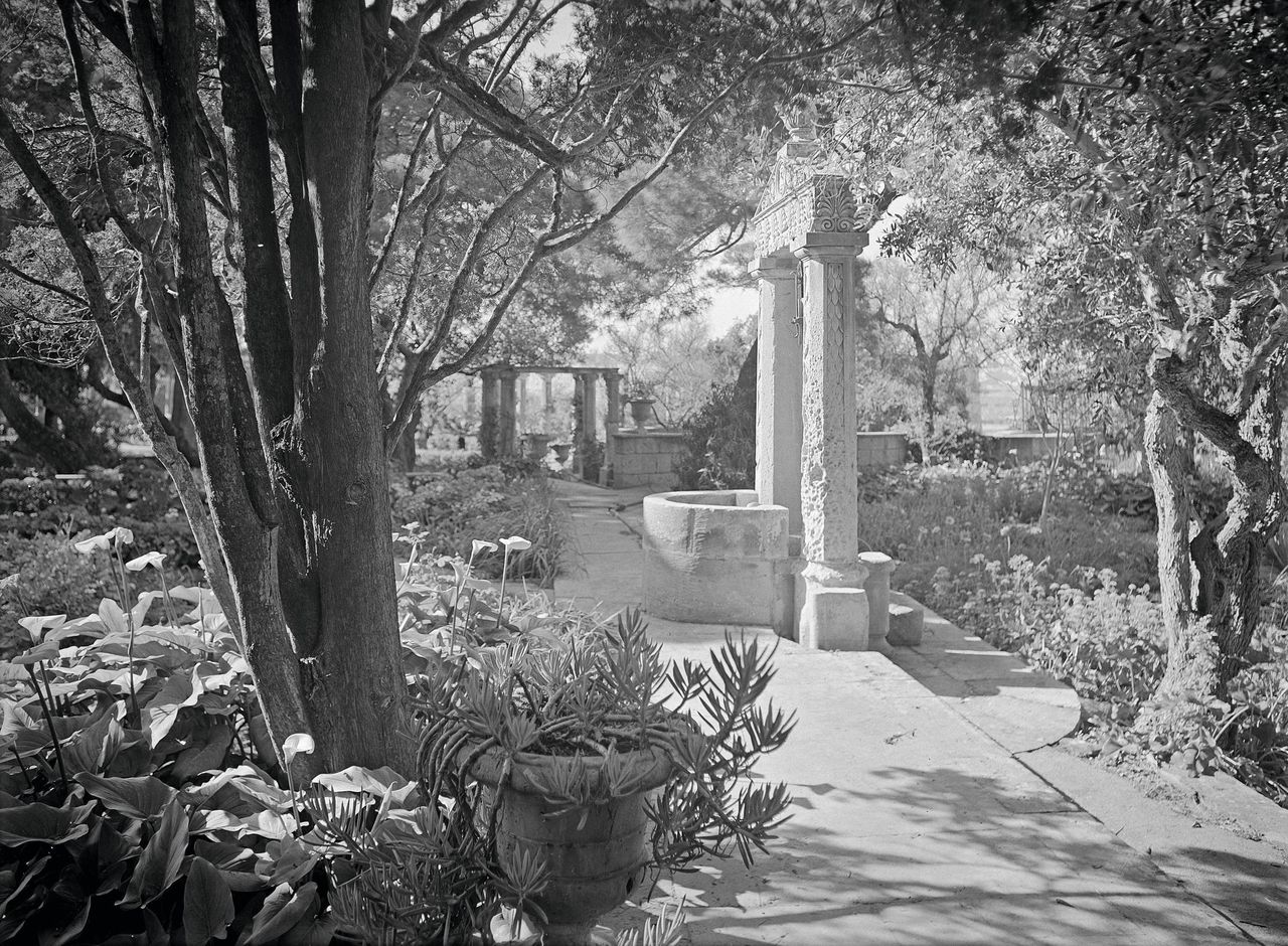 The gardens at Villa Frere as pictured in Country Life in 1930, showing one of the stone well heads that was removed during the Second World War for safekeeping. Credit: Country Life Picture Archive