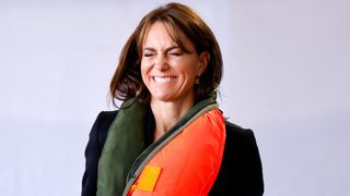 Kate Middleton making a funny face while wearing a life jacket