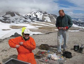 Lee Powell and John Paskievitch installing temporary seismic station at Mt. Mageik in the Katmai area of Alaska for a 2012 study on the volcanoes there.