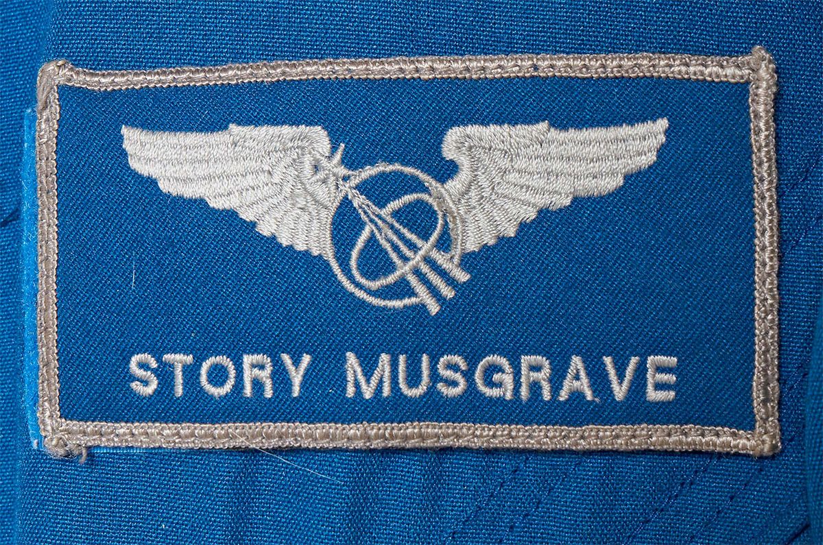 name patch on a blue astronaut flight suit that reads &quot;story musgrave&quot;