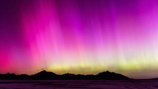  A geomagnetic storm lights up the night sky above the Bonneville Salt Flats on May 10, 2024 in Wendover, Utah. 