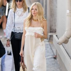 Sienna Miller wears cream dress and carries basket bag