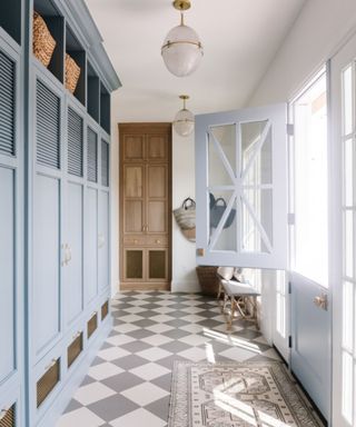 Pale blue hallway with diamond tiles, pendant lights and dutch doors