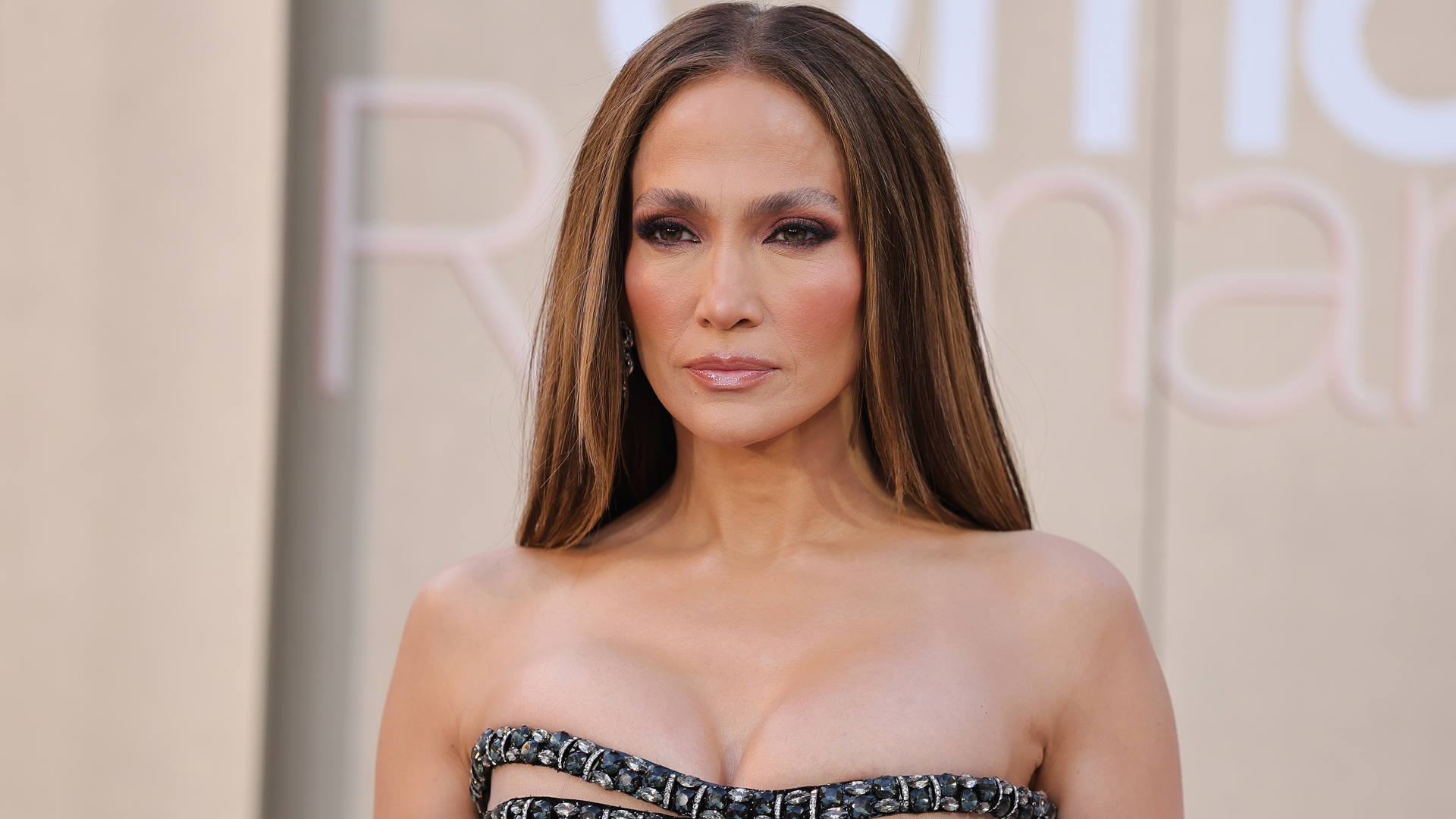Jennifer Lopez attended Netflix's Office Romance premiere in a vintage Versace ballgown with chest cut-outs