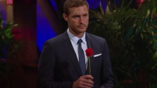 peter weber holding a rose at a dramatic rose ceremony