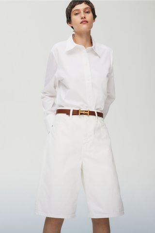 a model wears Bermuda baggy denim shorts in white 