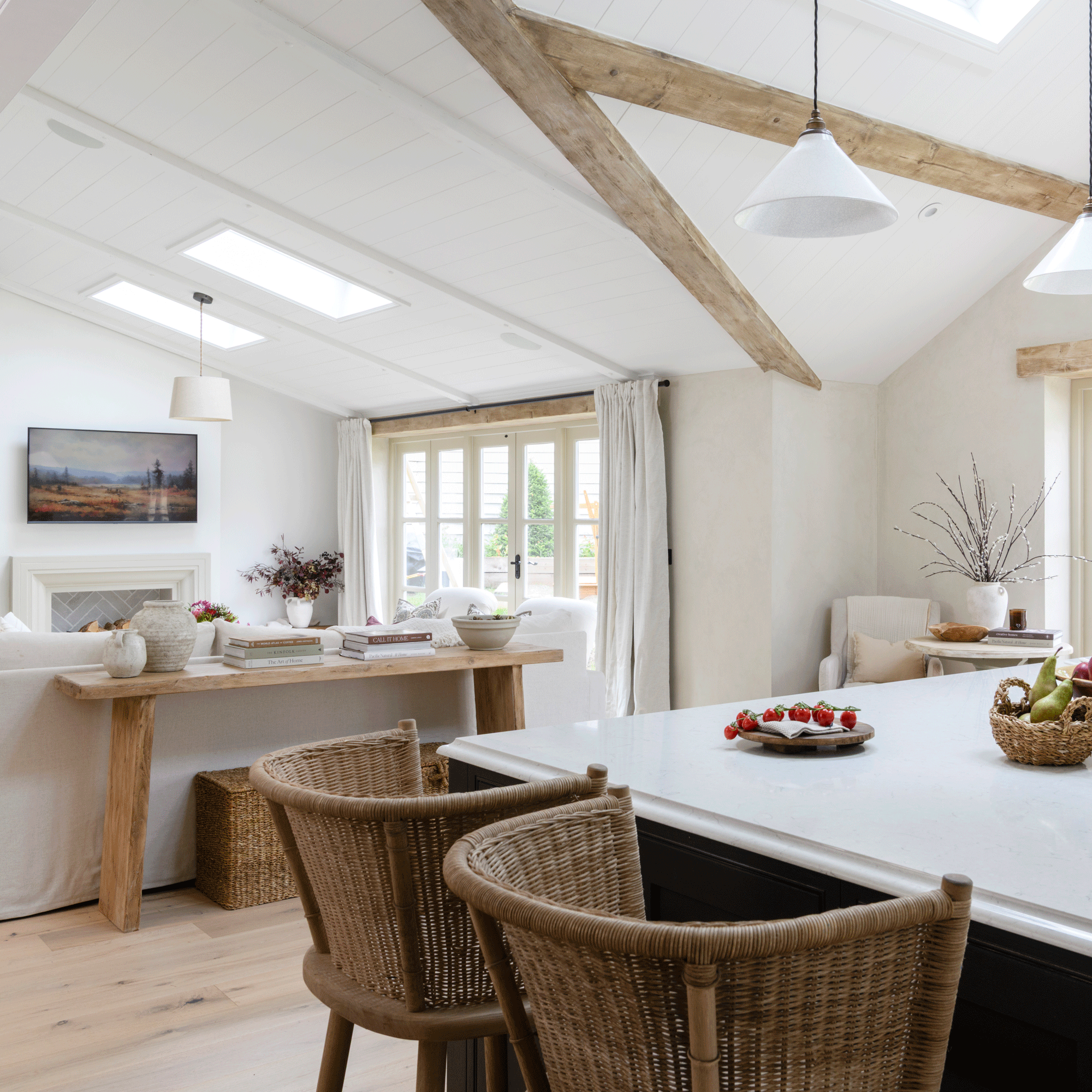 an open plan kitchen living areas with a black kitchen island and white sofa