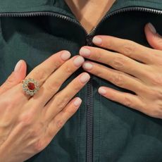 Lily Allen wearing a green jacket with a milky manicure