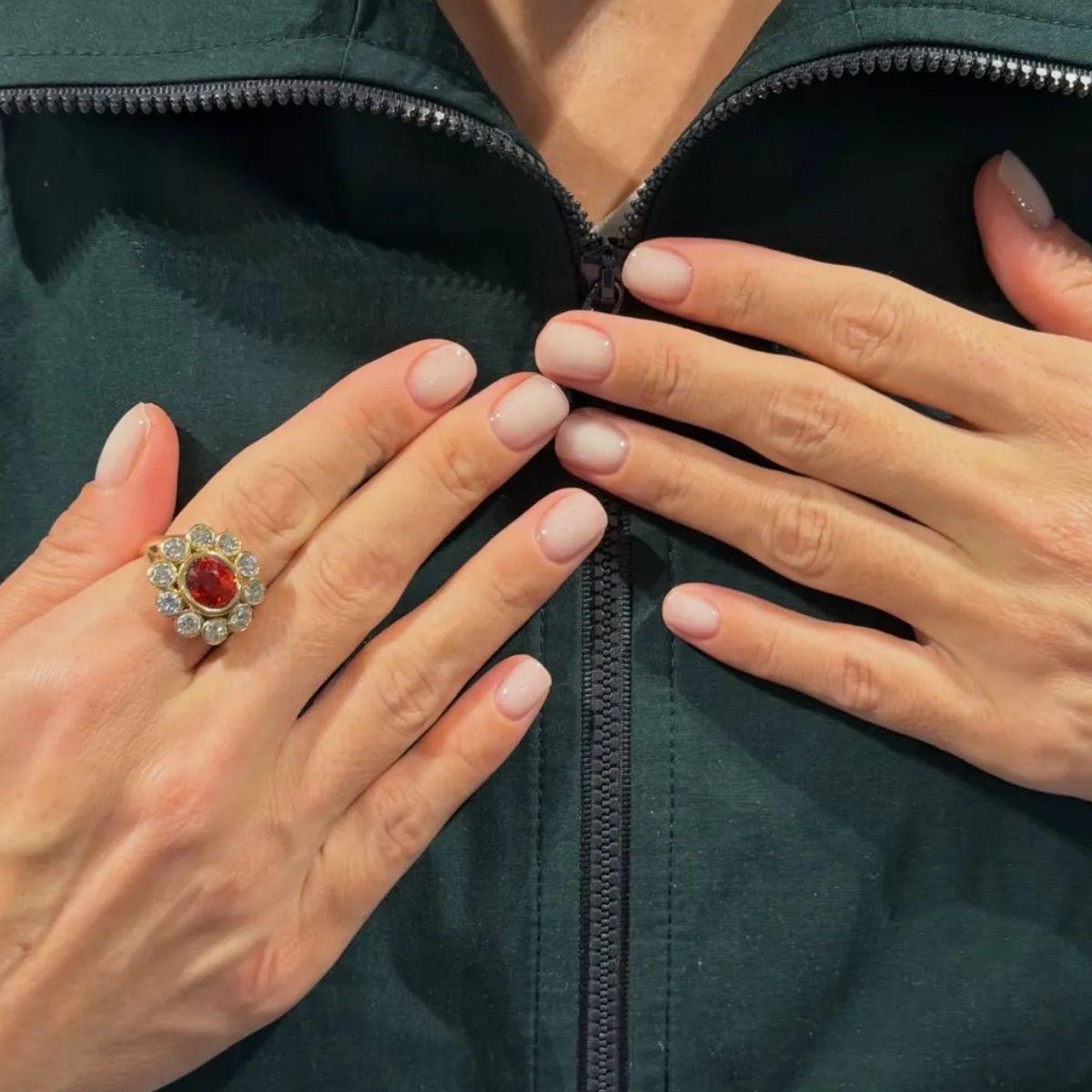 Lily Allen wearing a green jacket with a milky manicure
