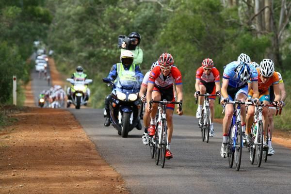 The seven-man break away is about to be caught by the peloton,