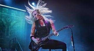 Nita Strauss performs with Alice Cooper on stage at Resorts World Arena on May 30, 2022 in Birmingham, England