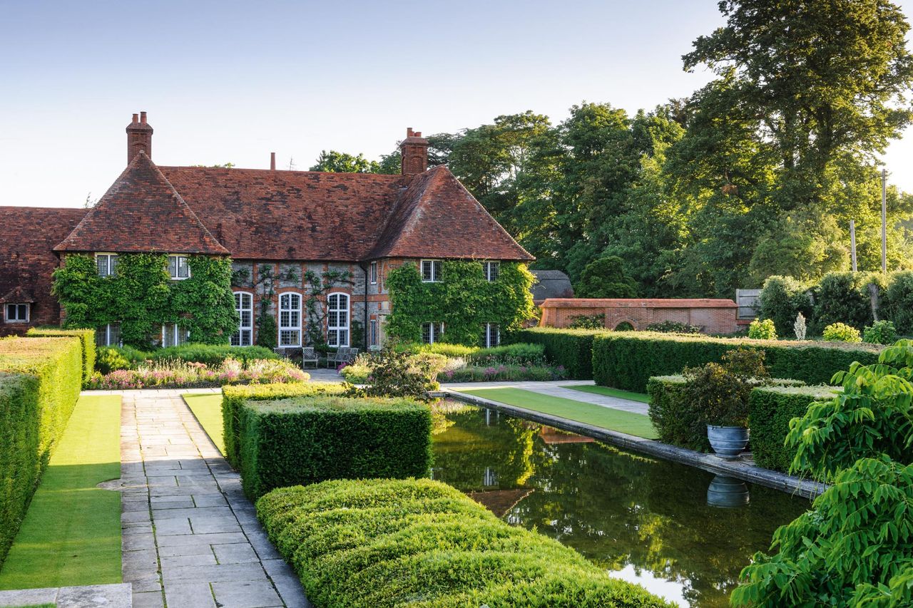 The Dutch Canal Garden, which was designed by Lutyens to perfectly reflect the William and Mary-style façade. Folly Farm in Sulhamstead, Berkshire.