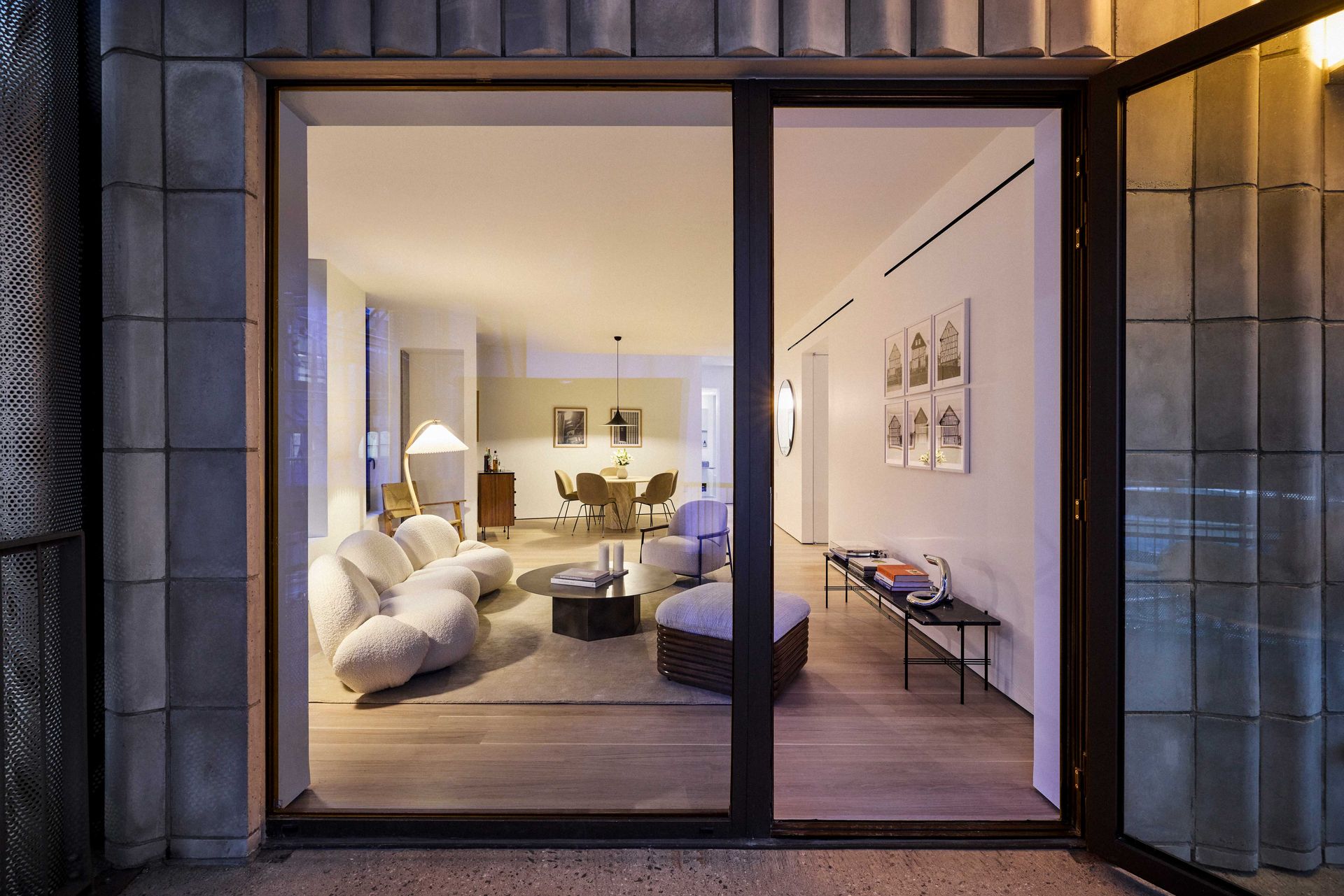 View into apartment from outside, at dusk, at Nine Chapel development Brooklyn