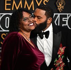 Anthony Anderson kisses his mom Doris Bowman on the cheek at the 75th Emmy Awards