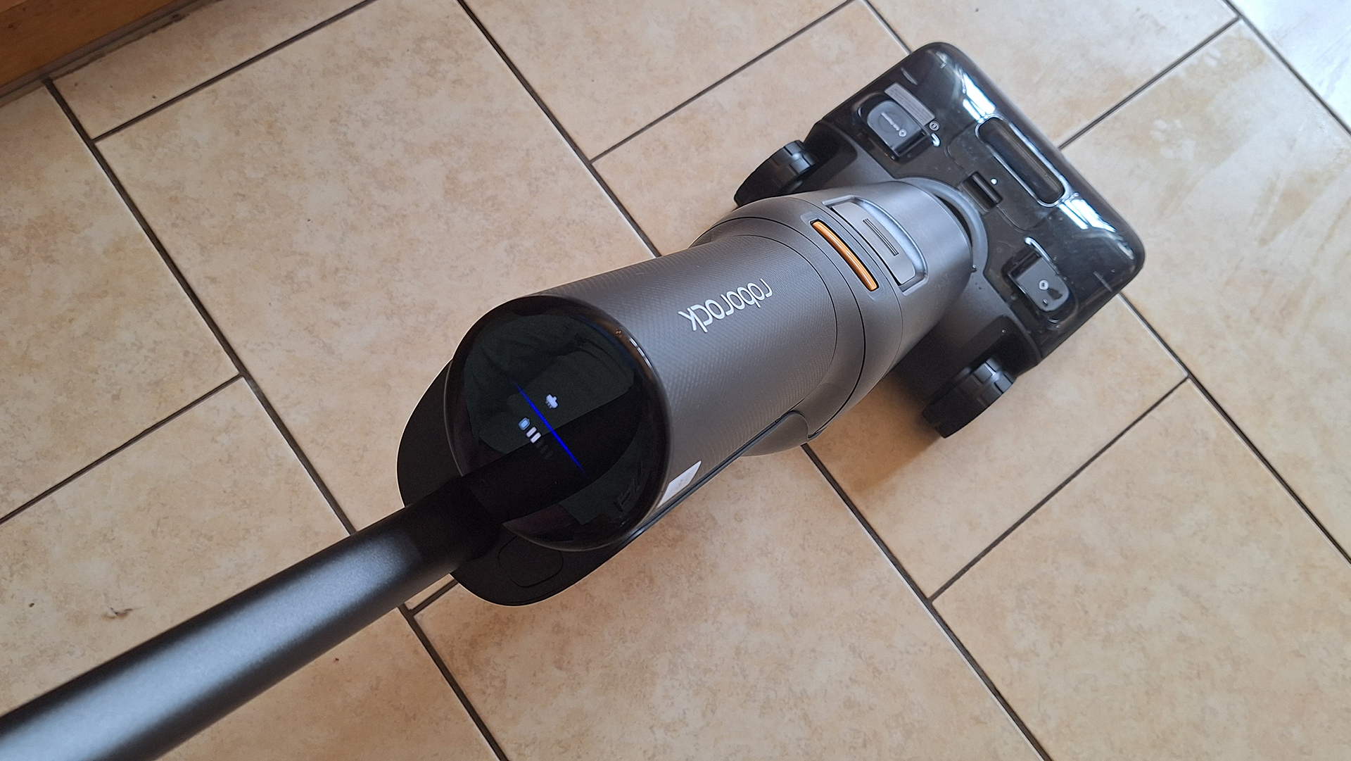 Person using Roborock F25 Ace Combo mop in a home with dogs running around