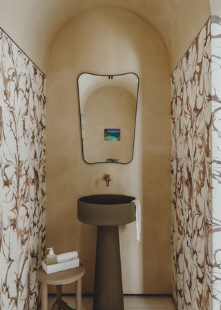 Statement curved ceiling flanked by marbled walls