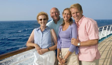 Two couples standing on the deck of a cruise ship.