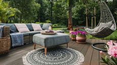 Amazon prime day ourdoor accents: an outdoor back yard with sofas, plant pots, an outdoor rug, and comfy chairs