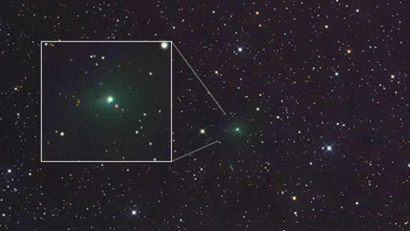 A space photo of a green comet surrounded by stars with a boxout highlighting the comet closer