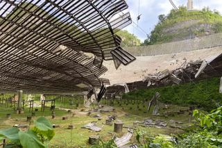 An image of the Arecibo Observatory's iconic radio telescope as seen between two serious cable failures that preceded the facility's collapse.