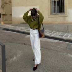 @juliesfi spring outfit photo in olive green sweater with white jeans and black flats