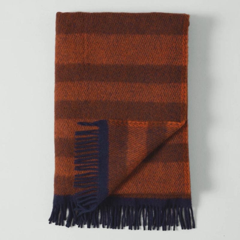 dark orange striped wool blanket with blue fringed edge