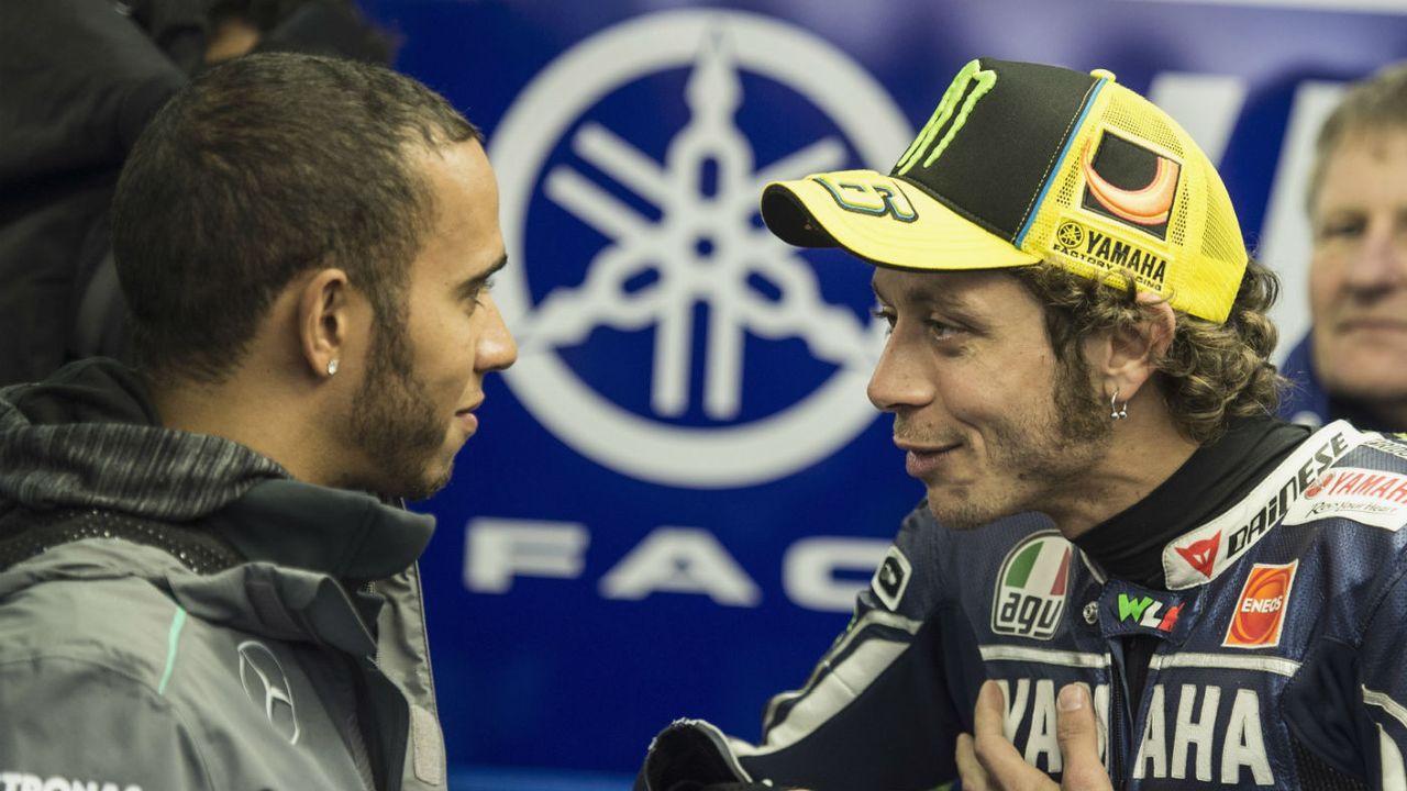 Formula 1 driver Lewis Hamilton speaks with MotoGP rider Valentino Rossi