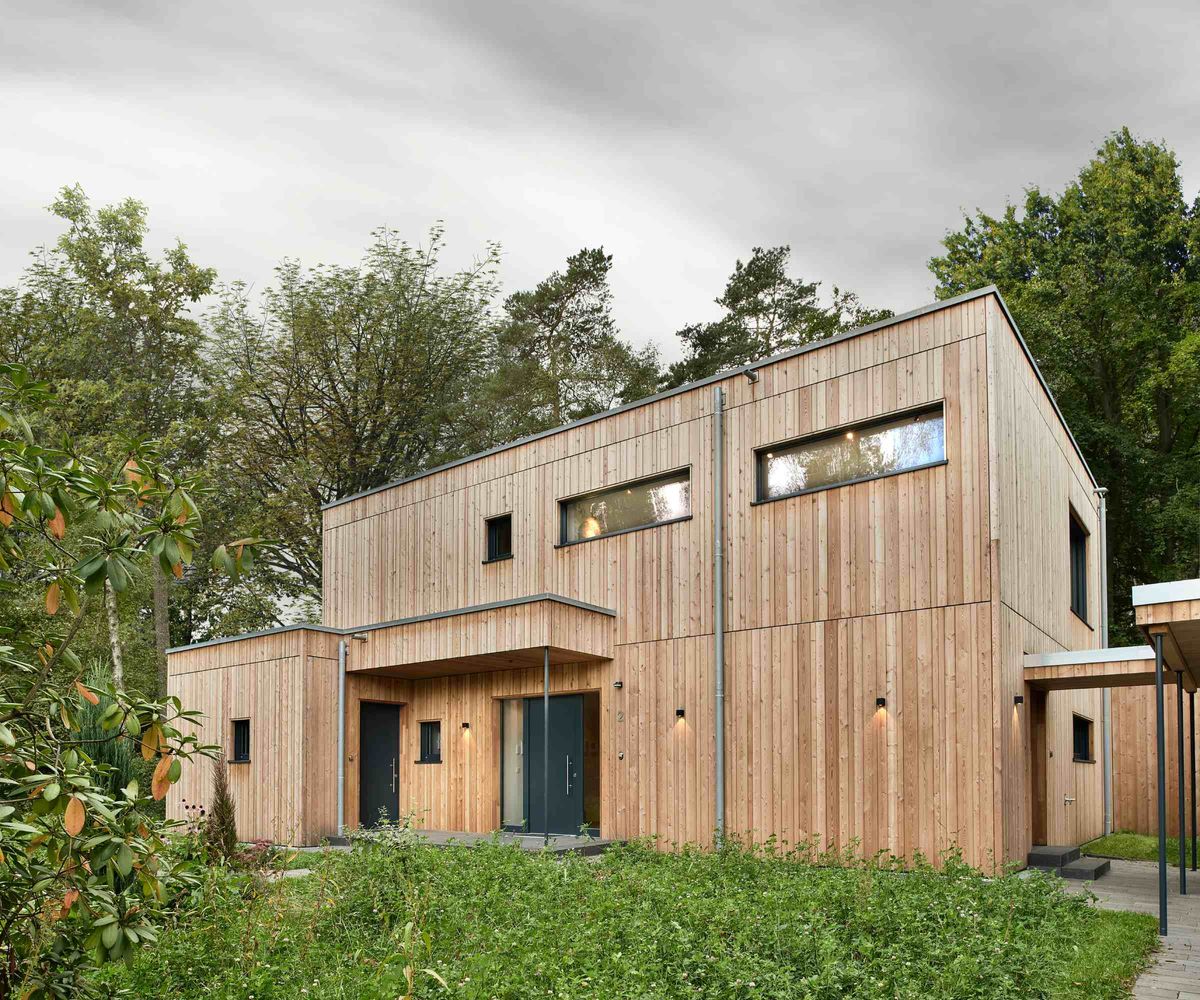 The front elevation of a timber-clad self build, built by Baufritz, and set on a woodland plot