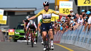 Demi Vollering of The Netherlands, in yellow and black, crosses the line ahead of the women&#039;s road race at the 2024 Paris Olympic Games.