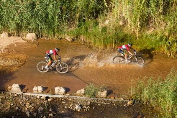 Kevin Evans and David George cross a river