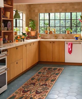 wooden retro mid century eclectic kitchen with blue floor tiles and a jungle themed runner rug