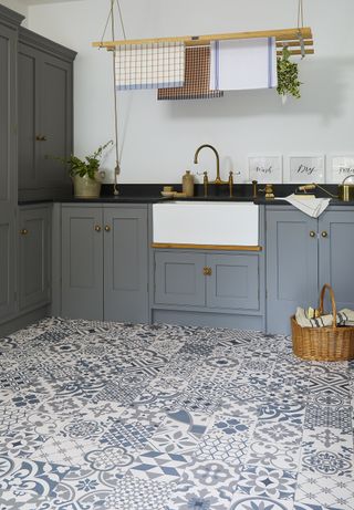 laundry room with patterned flooring, grey shaker cabinets and a ceiling-hung dryer