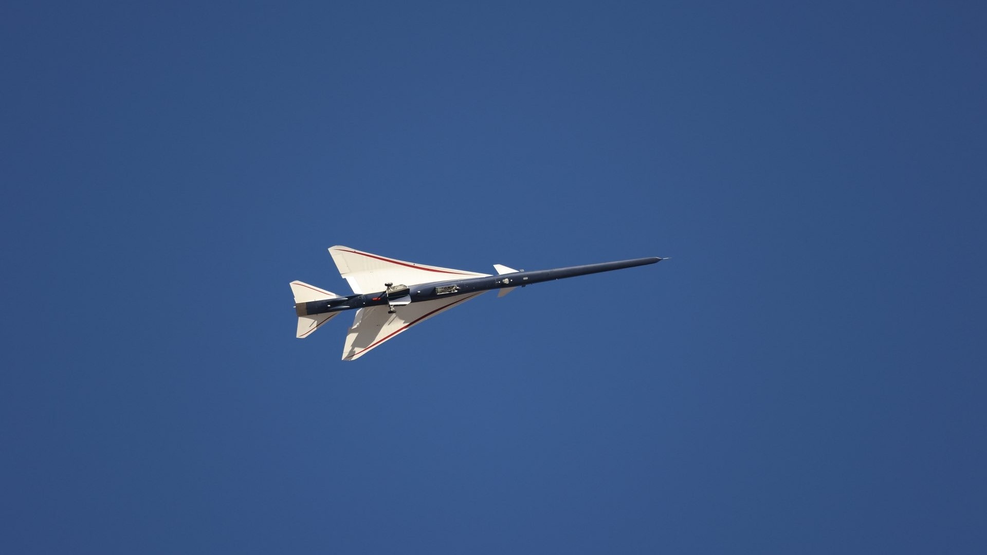 an elongated blue-and-white jet in flight