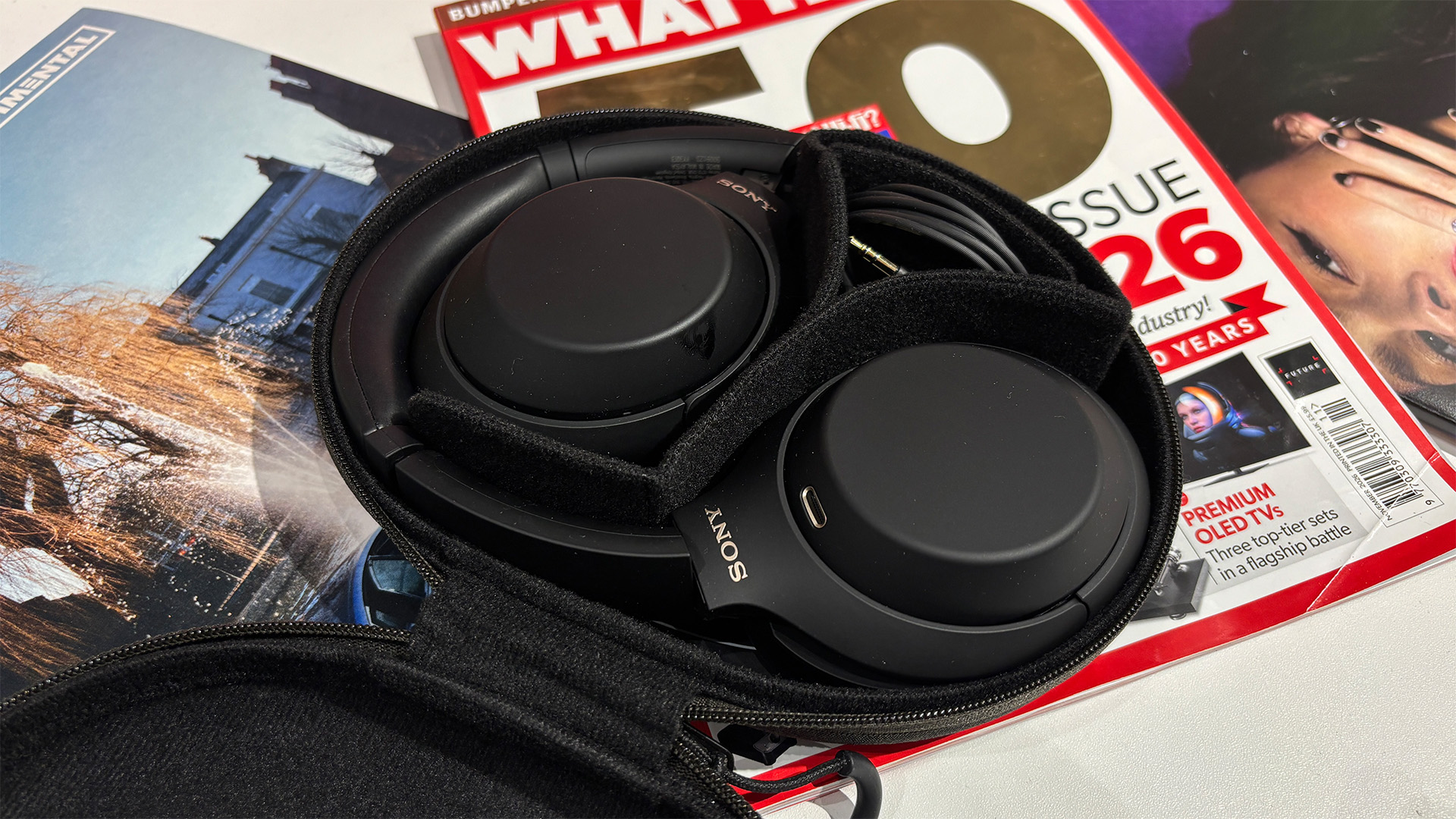 Sony WH-1000XM4C over-ear headphones in open case on top of What Hi-Fi? magazine