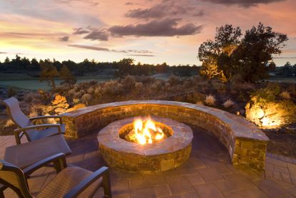 stone fire pit with outdoor chairs