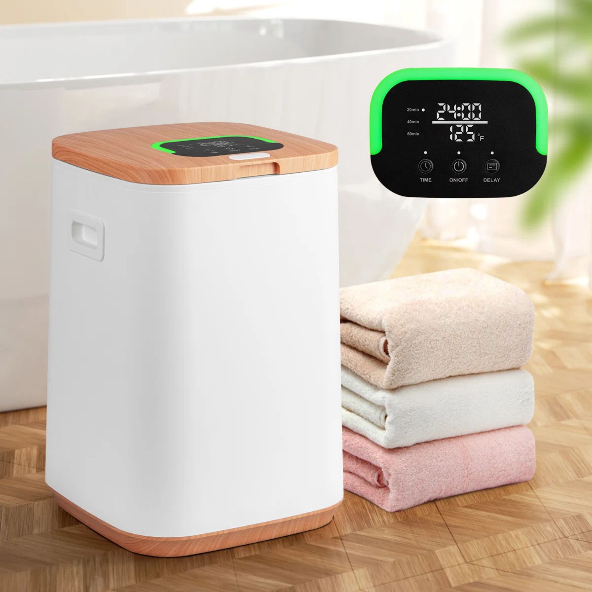 White towel warmer from Wayfair 22l with three folded towels next to it