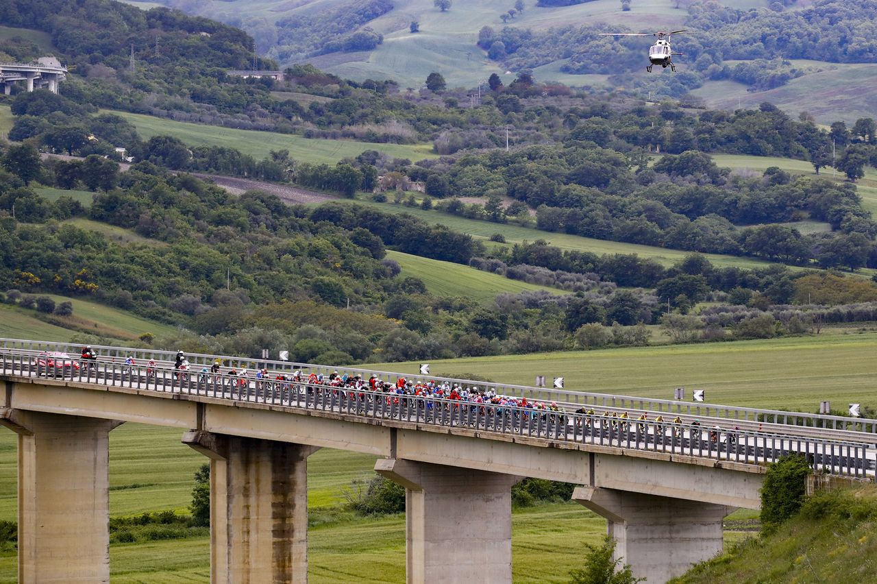 The peloton pass across a bridge during stage 6