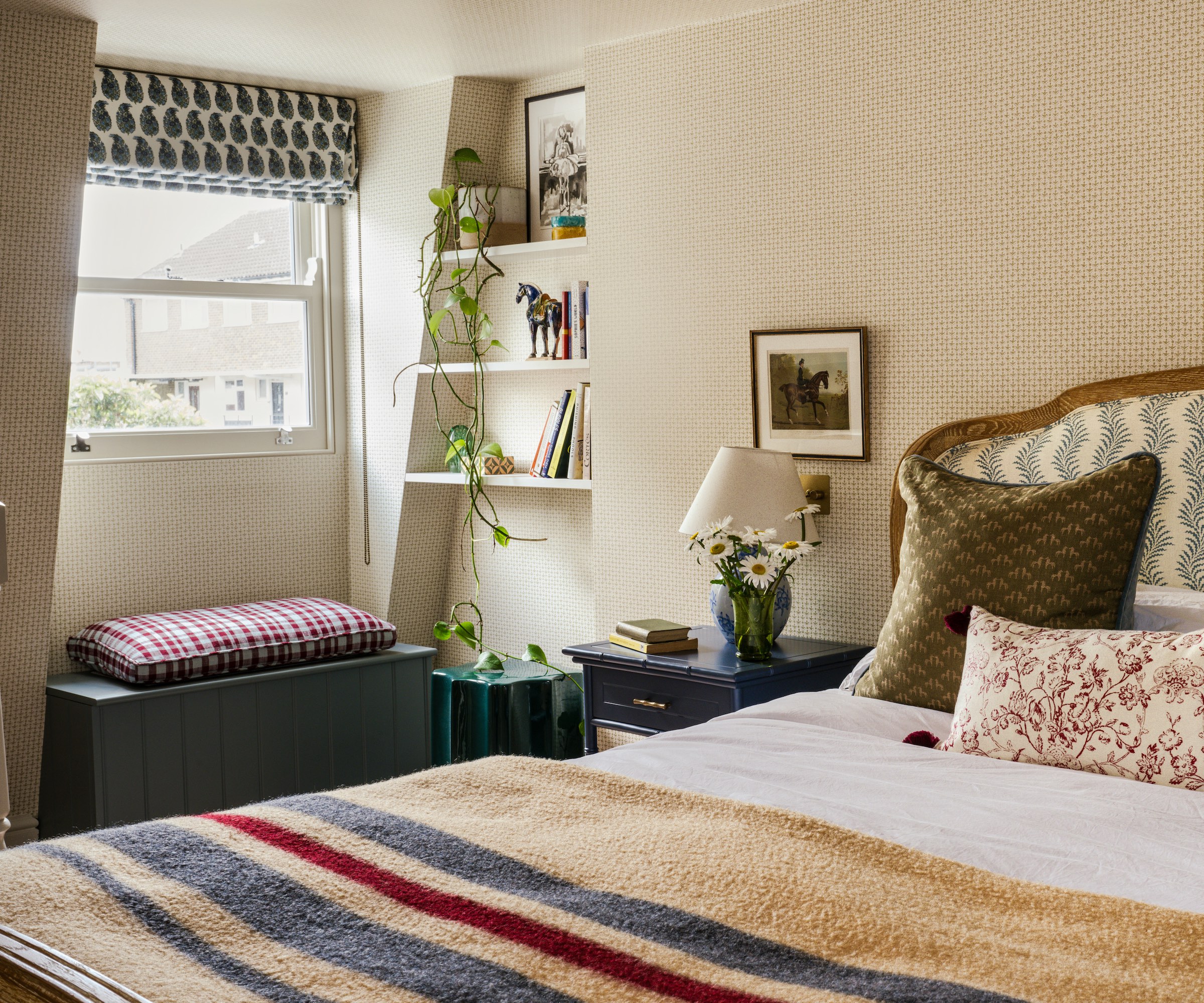loft with striped bed cover and window and niche shelving