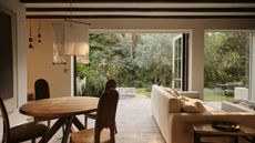 tiled living room with French doors opened to a garden