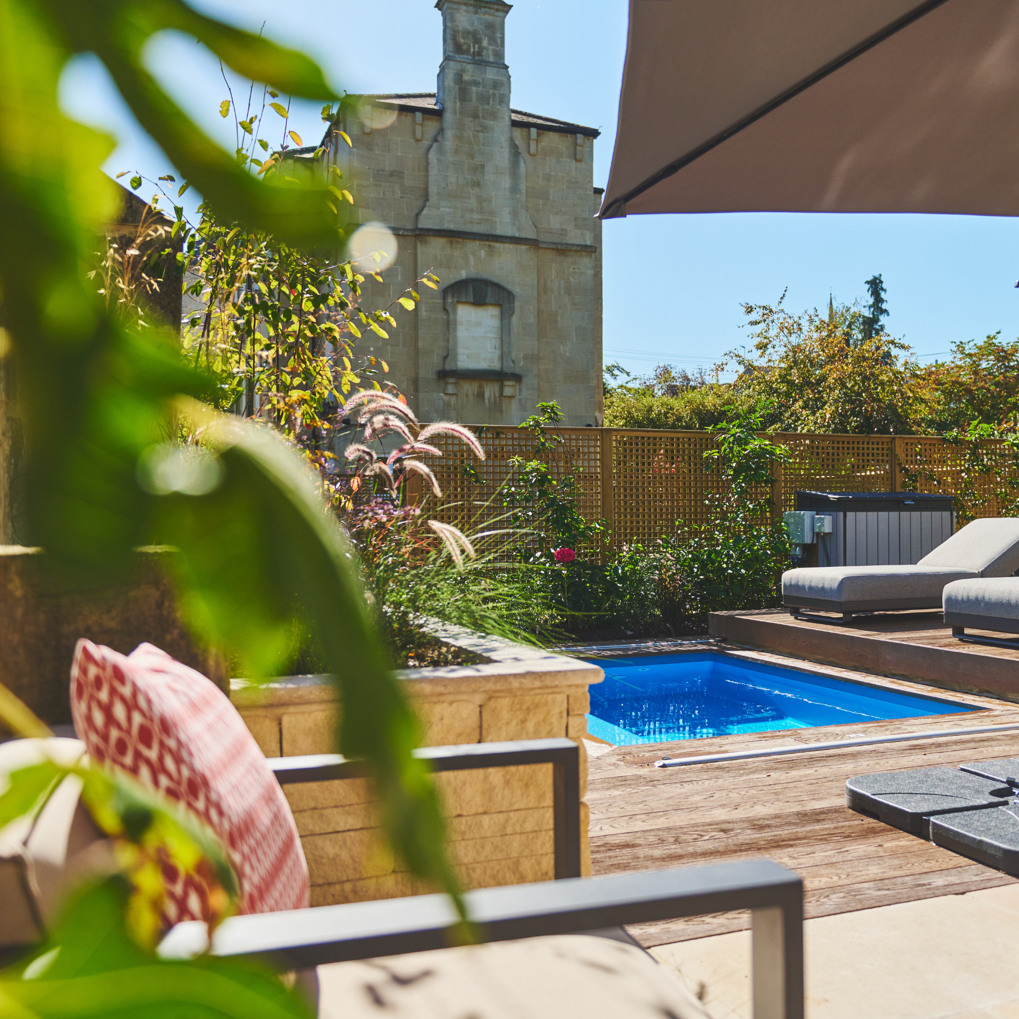 Compass plunge pool in situ in a back garden with decking