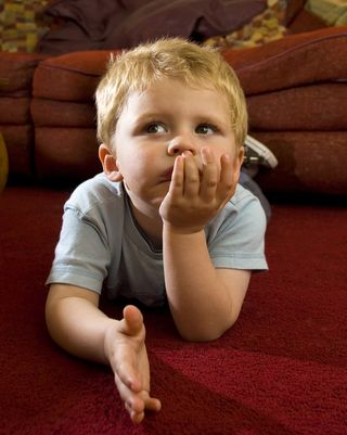 toddler on floor watching television